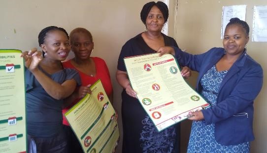 Sedibeng district information officers and partners receiving DHMIS SOP posters